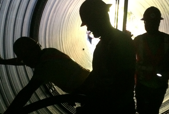 Workers reline a culvert using Contech Engineered Solutions Materials. 