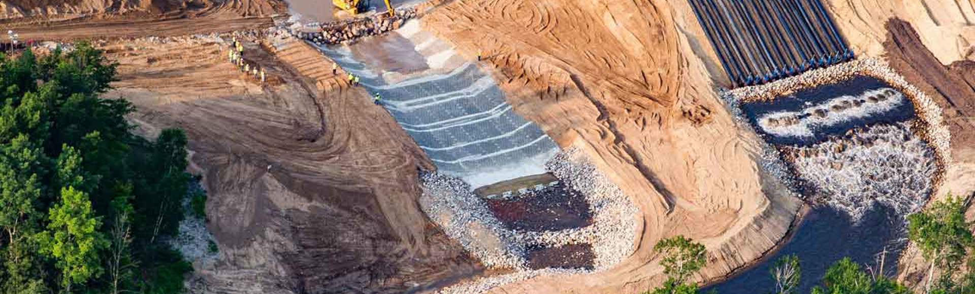 A dam spillway is being lined with Armorflex cellular concrete blocks.