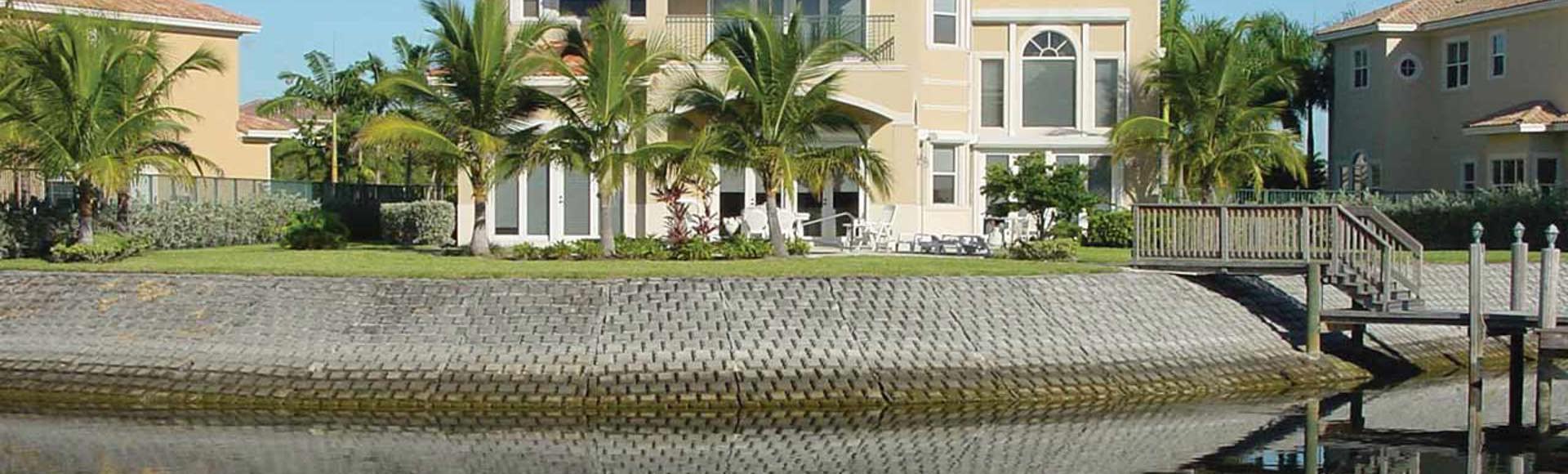 Contech Hard Armor protects the shoreline of a large house from erosion. 