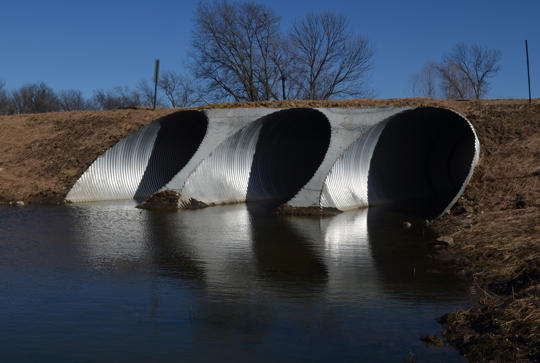 A large culvert made from corrugated metal pipe. 