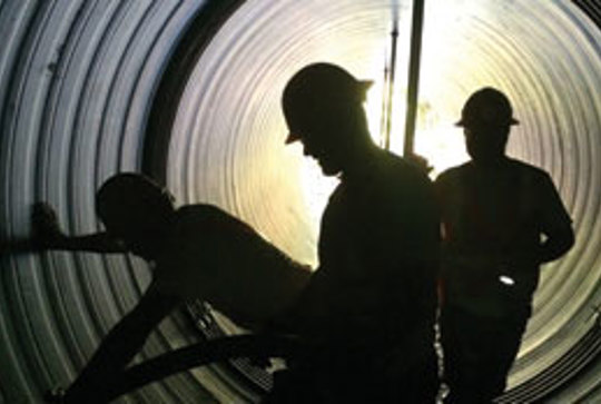 Workers reline a culvert using Contech Engineered Solutions materials.