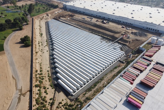 An aerial view of a large corrugated metal pipe stormwater underground detention system. 