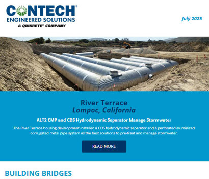 Large stormwater pipes installed underground at a construction site with workers and equipment visible in the background.