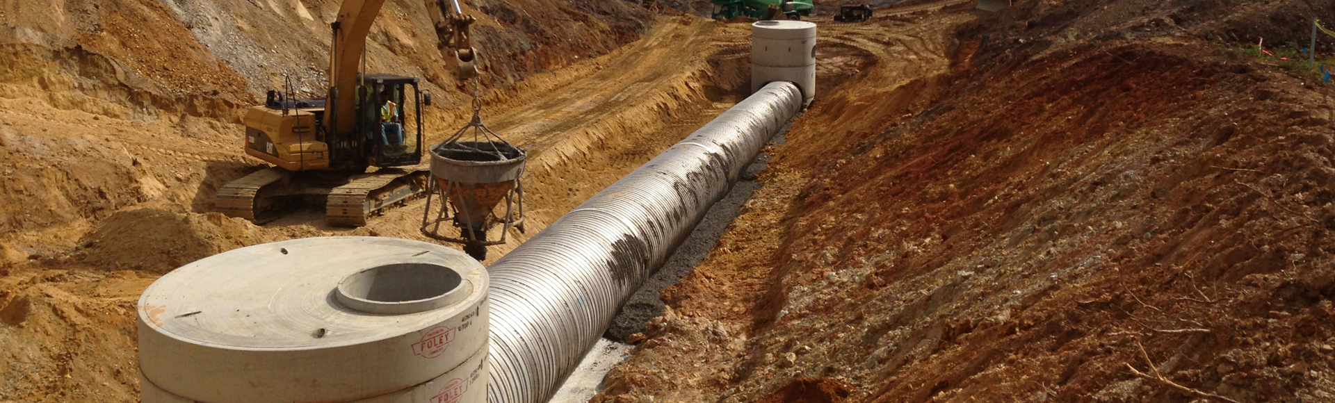 A storm sewer under construction made from Contech corrugated metal pipe. 
