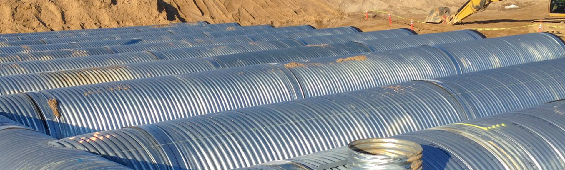 A corrugated metal pipe stormwater detention system is under construction. 